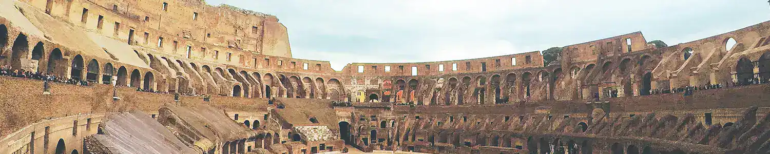 Ancient Roman Colosseum with historic architecture and arches.