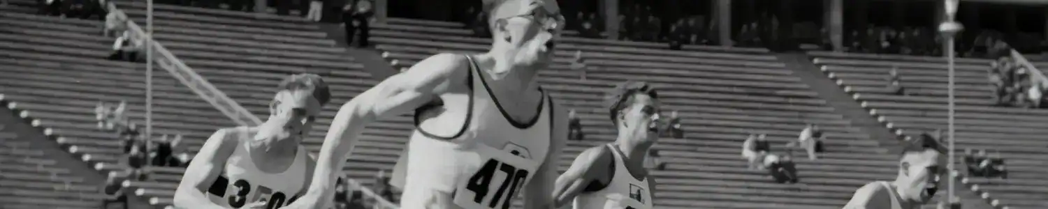 Athletes competing in a track and field event at a historic stadium.